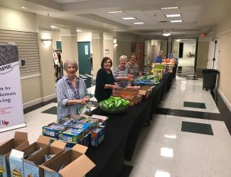 Volunteers help pack snack bags
