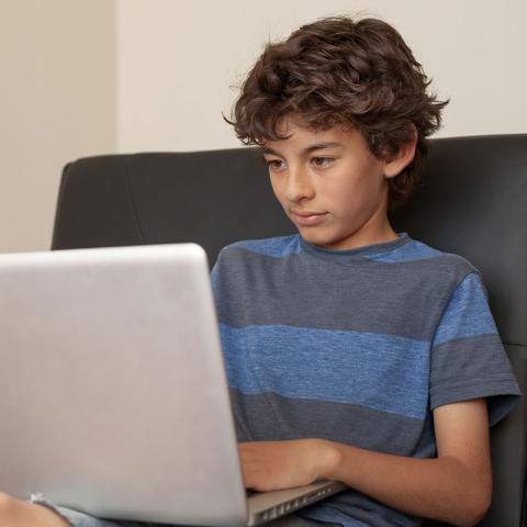 Boy using laptop computer