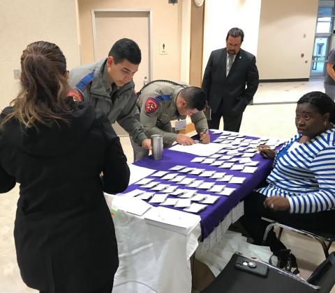 Officers signing in to a conference
